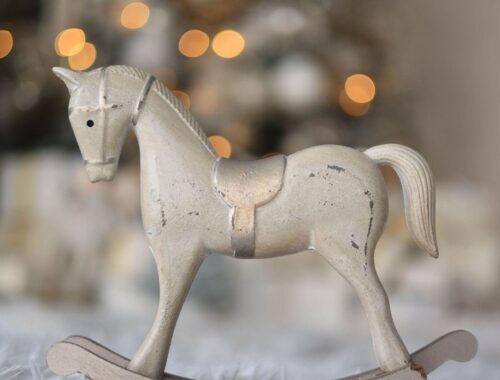 White rocking horse, beige tones.