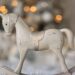 White rocking horse, beige tones.